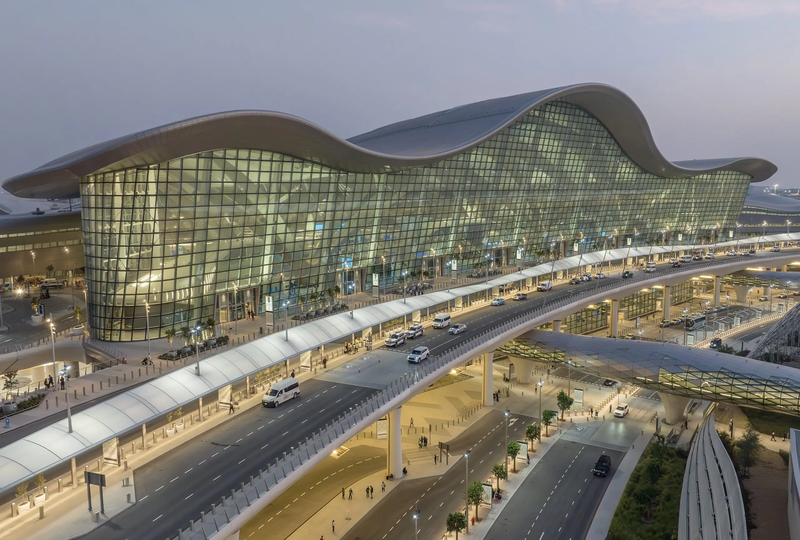Zayed International Airport's sweeping roofline at dusk