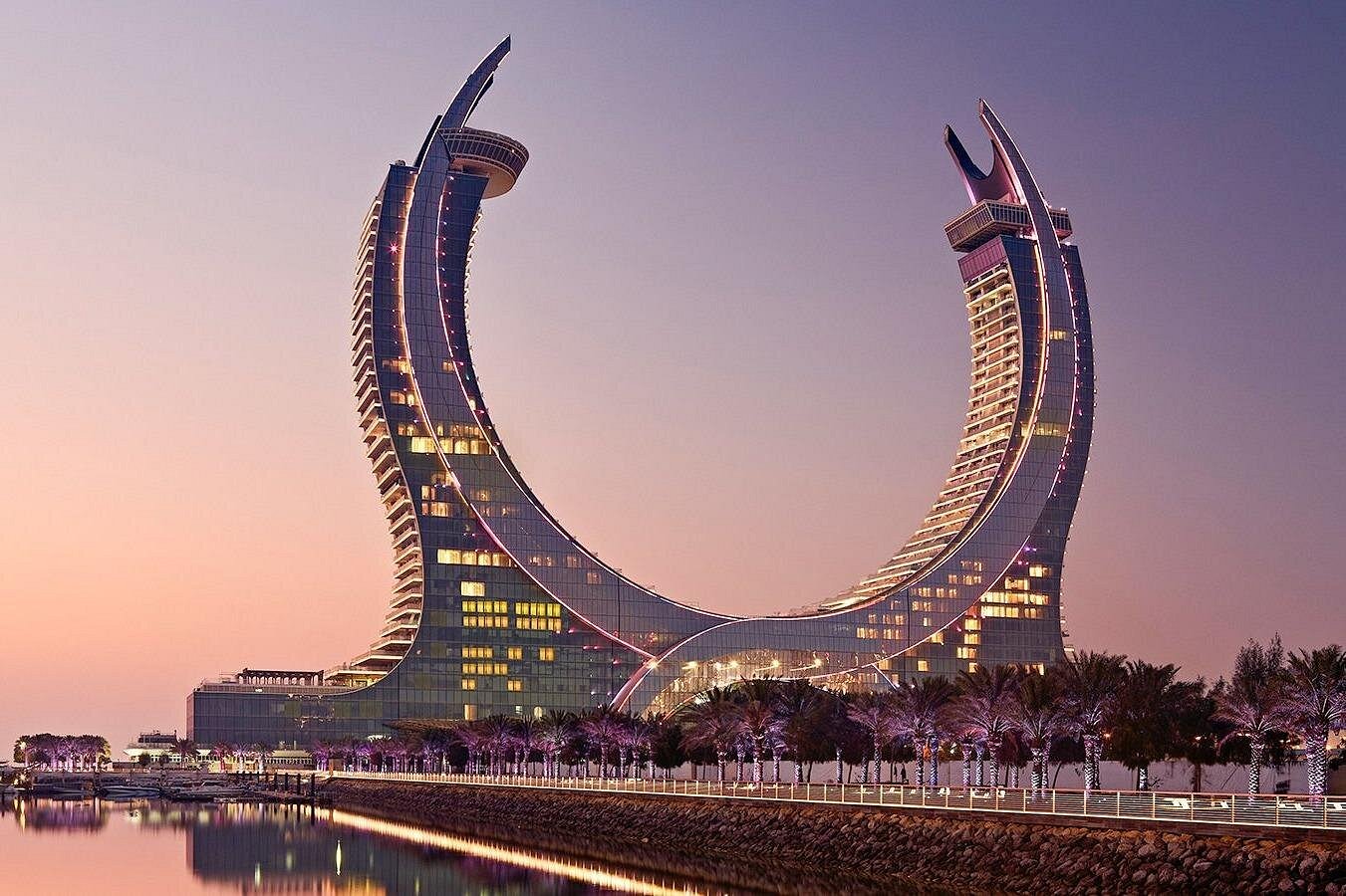 The curved Katara Towers at sunset