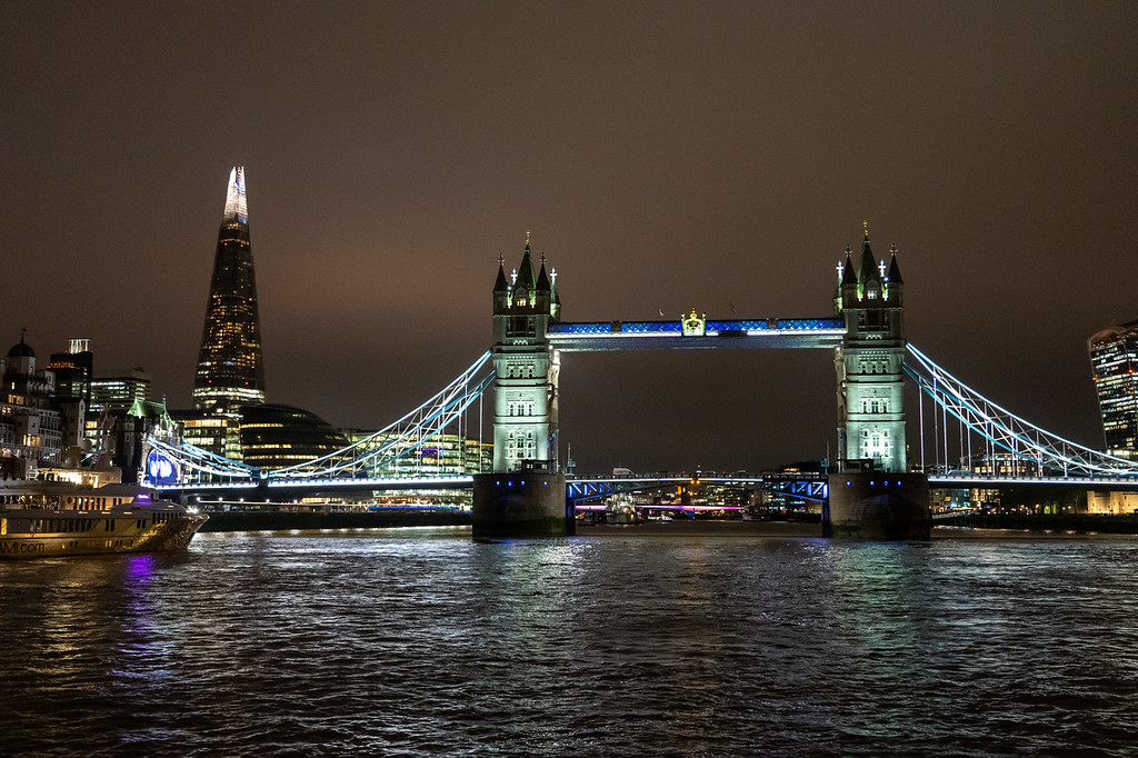 Tower Bridge and the Shard illuminated at night, seen from a Thames cruise