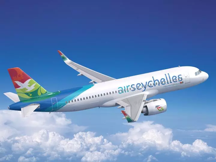 Air Seychelles Airbus A320neo in flight above clouds