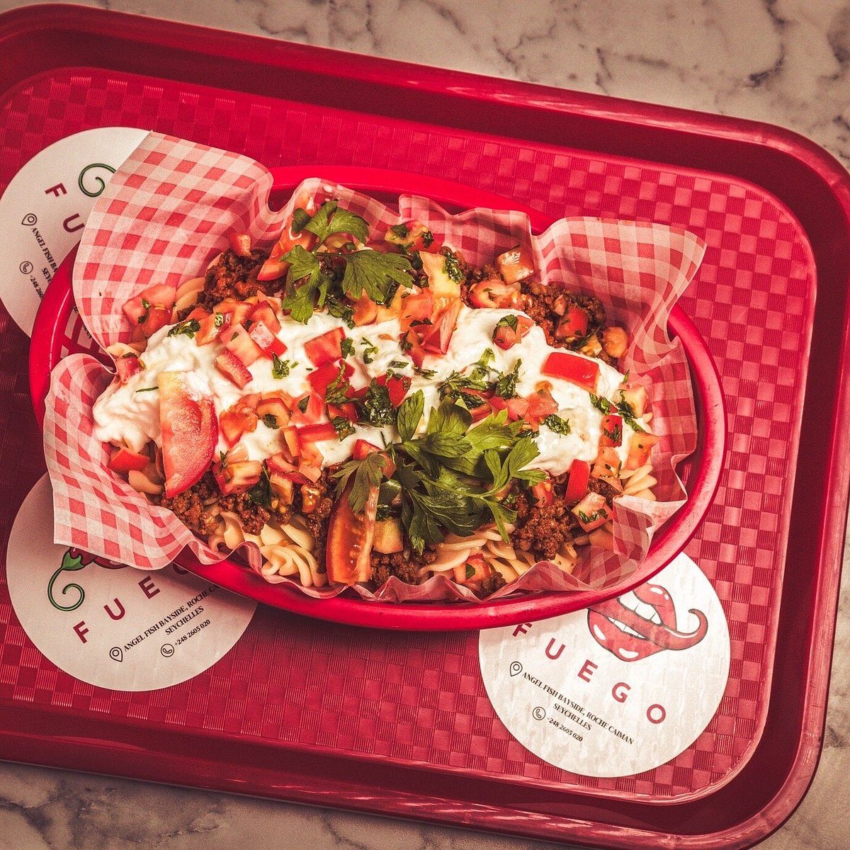 Loaded pasta dish with mince, cheese and fresh tomato at Fuego Bistro